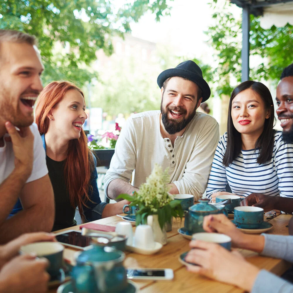 Friends laughing together around a table